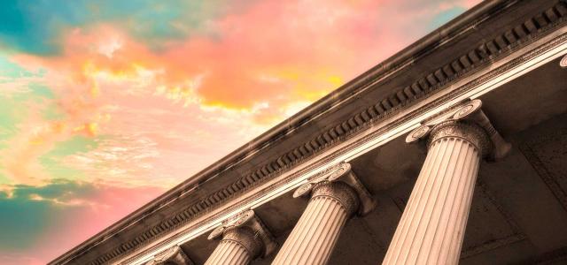 Classical Columns on Government Building with Colorful Sky